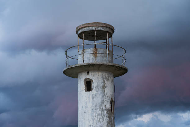 istock The old Neeme lighthouse against the backdrop of thunderclouds at sunset. 2166925820