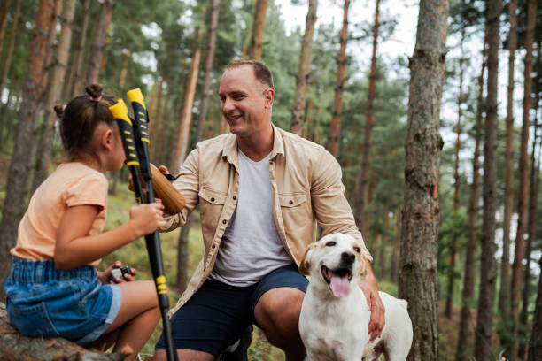 istock Dad and daughter hiking with a dog 2166926043