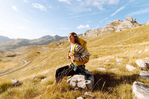 istock A young woman walks along a path among the dry grass. 2166926126