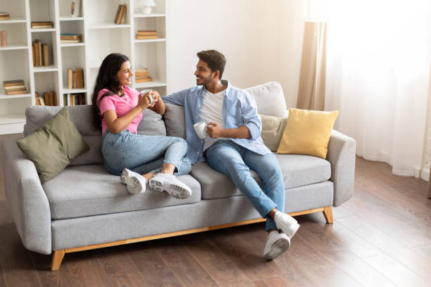 istock Indian couple chatting over coffee on cozy sofa at home 2166926128