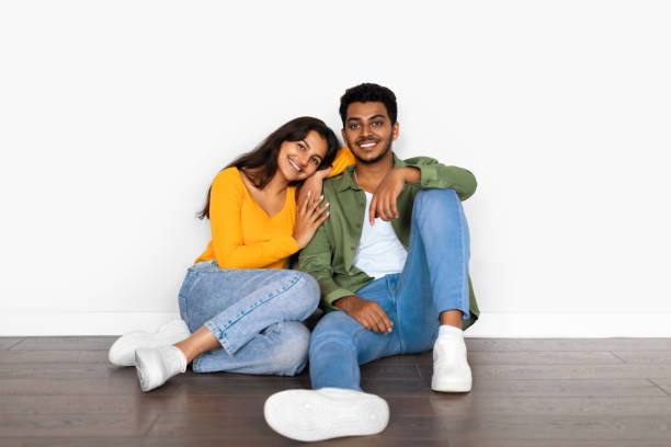 istock Affectionate hindu couple cuddling while seated on floor 2166926140