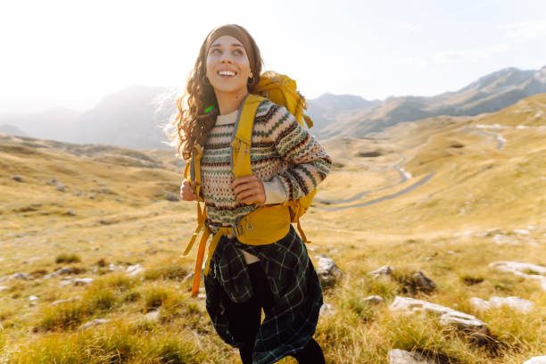istock A young woman walks along a path among the dry grass. 2166926144