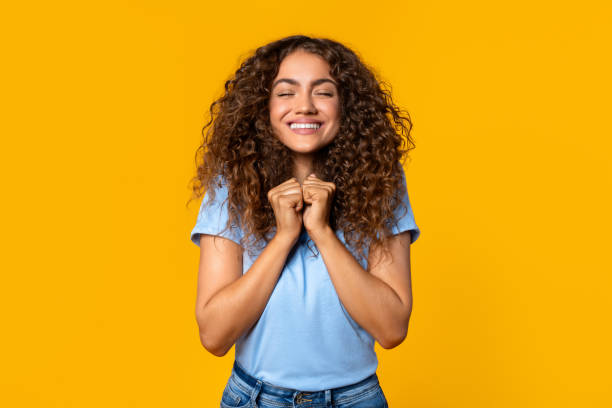 istock Young woman with clenched hands in delight 2166926370