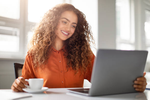 istock Smiling woman enjoying video call on tablet 2166926380