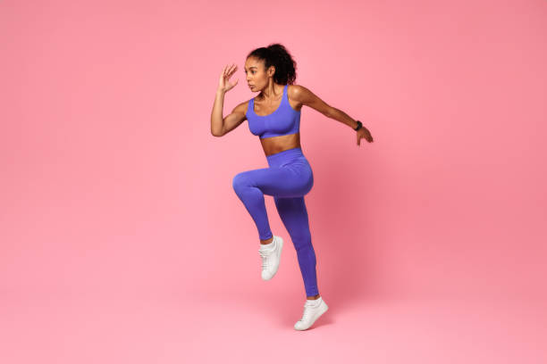 istock Athletic African Lady Jumping Exercising During Training Over Pink Background 2166927543
