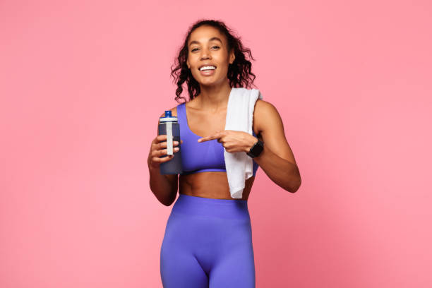 istock Active woman with a towel pointing at bottle 2166927633