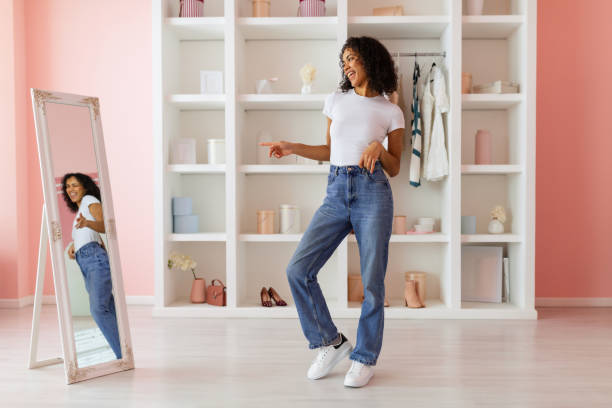 istock Playful woman dancing in jeans, reflection in mirror 2166927693