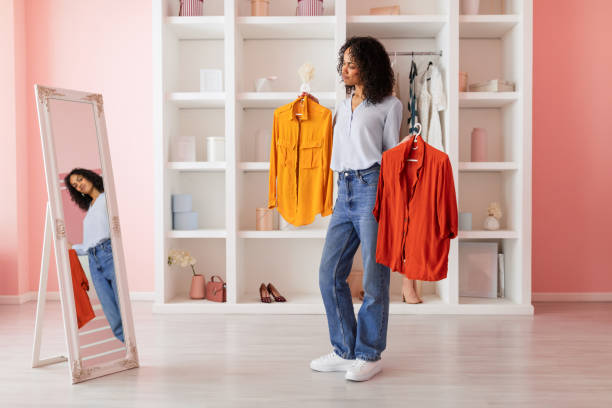 istock Decisive moment, latin woman choosing between two shirts 2166927701