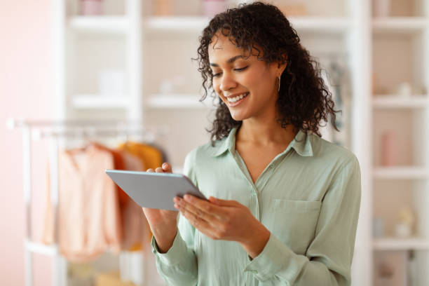 istock Focused latin woman with tablet in light-filled design studio 2166927720