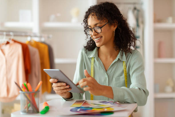 istock Designer with tablet and color chart at a fashion studio 2166927742