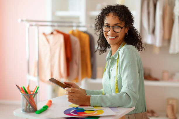 istock Cheerful designer with tablet selecting colors in studio 2166927748