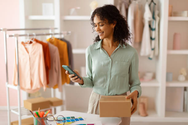 istock Entrepreneur with smartphone and parcel, organizing shipment 2166927754