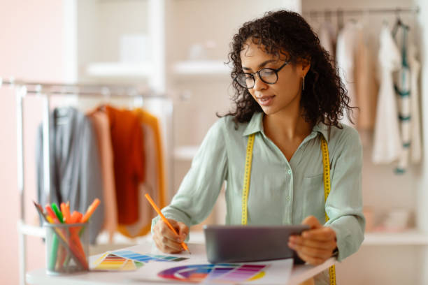 istock Designer with tablet selecting color swatches 2166927761