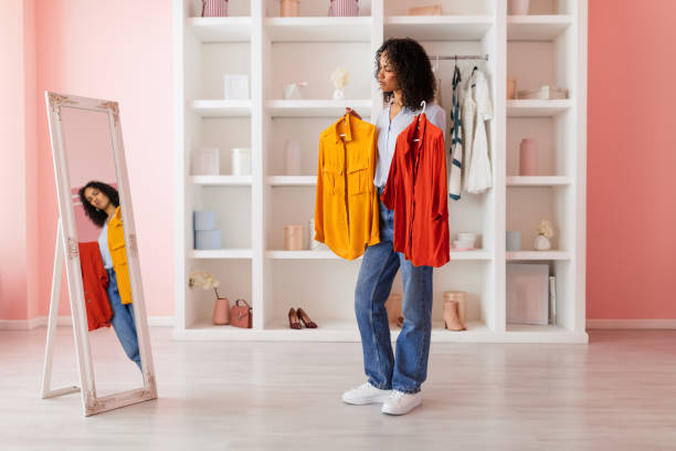 istock Woman choosing between yellow and red shirts 2166927779