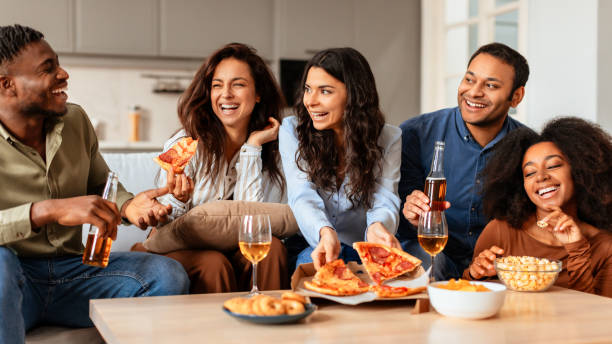 istock Friends laughing and sharing drinks at home 2166928242