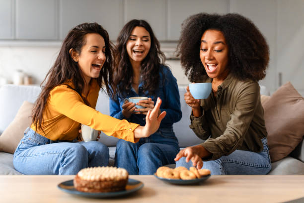 istock Cheerful friends sharing a joyful moment at home 2166928263