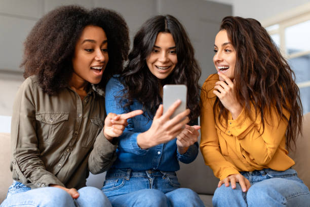 istock Captivated friends viewing a smartphone at home 2166928273