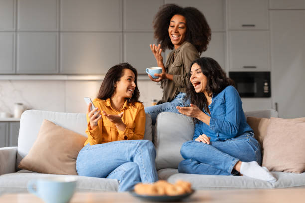 istock Casual moment girlfriends laughing and drinking coffee 2166928297