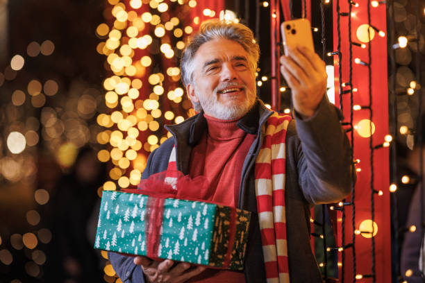 istock Joyful mature man taking a selfie during Christmas celebration 2166928431
