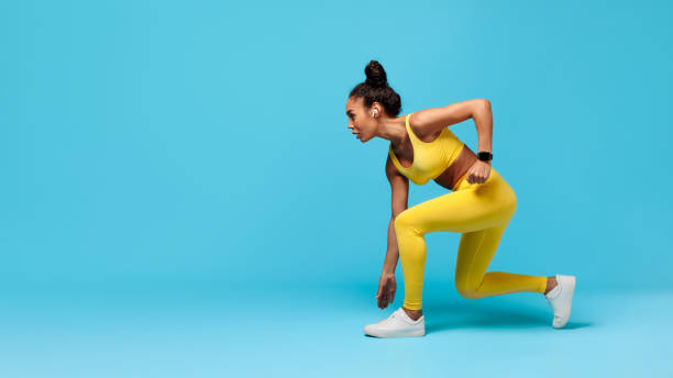 istock African American Woman Runner Doing Crouch Start Over Blue Background 2166928826