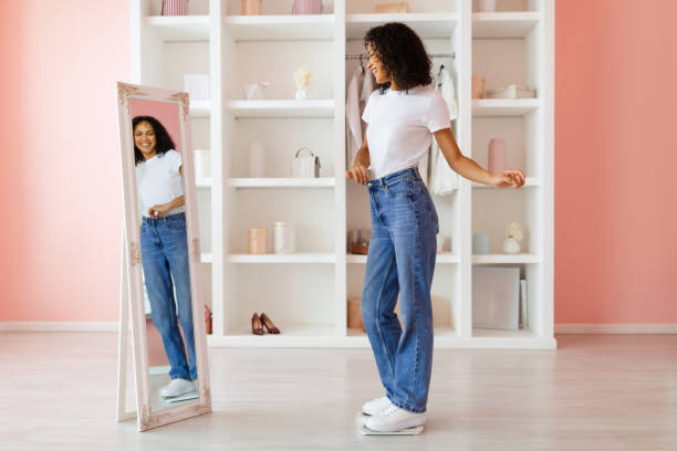 istock Woman in jeans dancing in front of mirror 2166928863