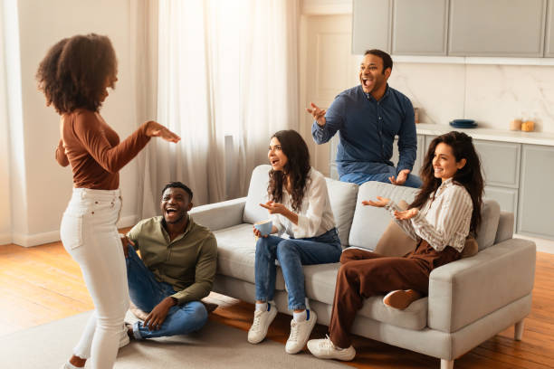 istock Friends conversing and laughing together at home 2166929076
