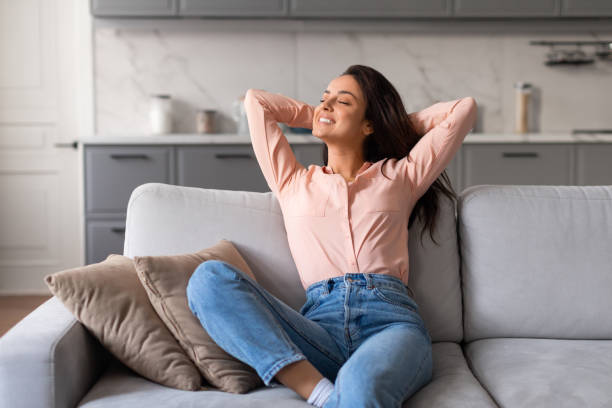 istock Relaxed woman enjoying peaceful moment on comfy couch 2166929152