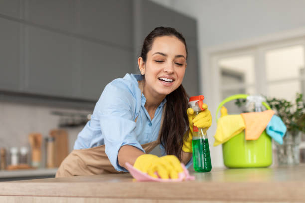 istock Cheerful woman cleaning kitchen countertop 2166929179