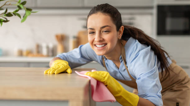 istock Joyful woman cleaning table with cloth, free space 2166929205