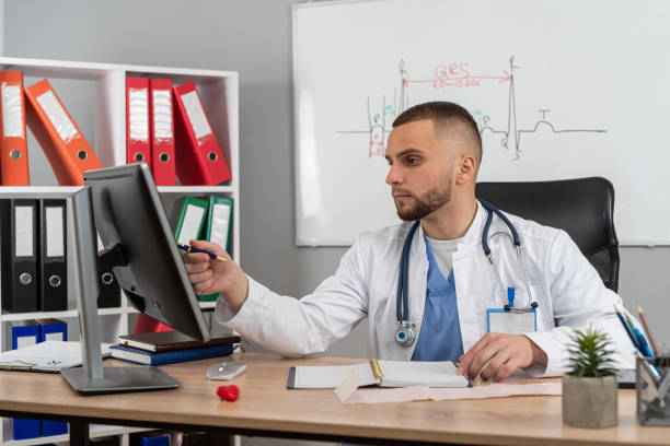 istock doctor man sitting at the desk using laptop computer for webinar training ar medical themes 2166929324