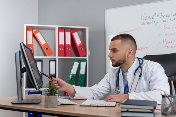 istock Therapist practitioner wear white uniform coat with stethoscope working with patientes files 2166929390