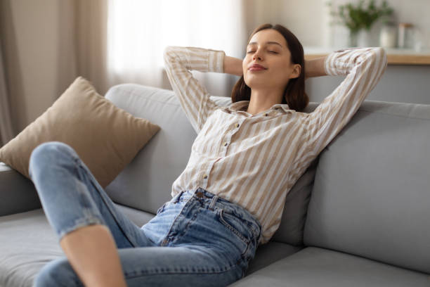 istock Woman relaxing on couch, serene and content 2166929663