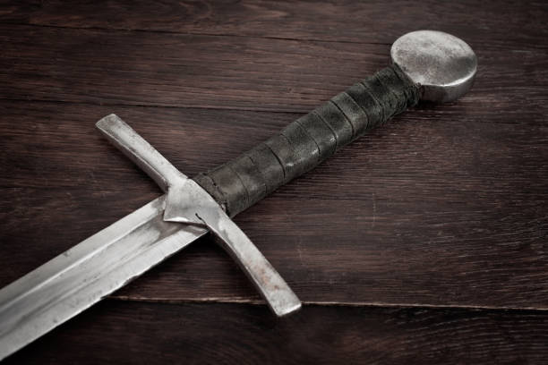 istock Medieval sword on wooden background. 2166931169
