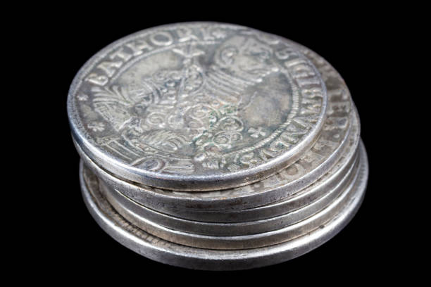 Stack of old vintage silver medieval taller coins on black background