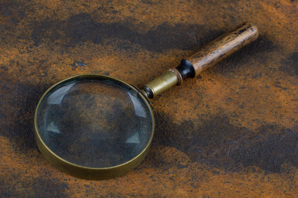 istock magnifying glass on metal rusty background, 2166931264