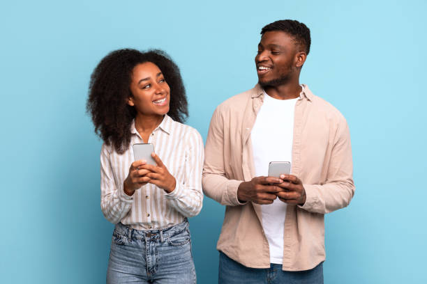 istock Black couple sharing moment with their smartphones 2166932089
