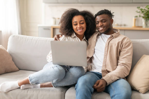 istock Young Black Spouses Using Laptop Together Browsing Internet At Home 2166932476