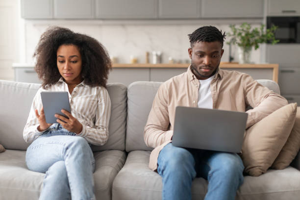 istock Modern millennial black couple browsing on laptop and tablet indoor 2166932517