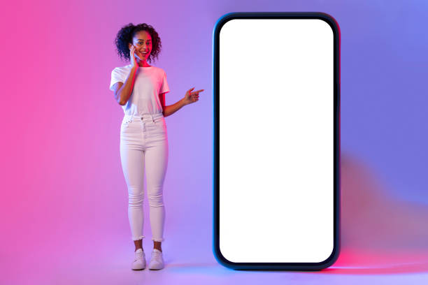 istock Woman pointing at giant white blank phone screen 2166933443