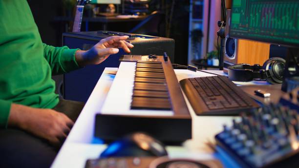 istock Music engineer producing song by mixing and mastering tunes on audio console 2166933491