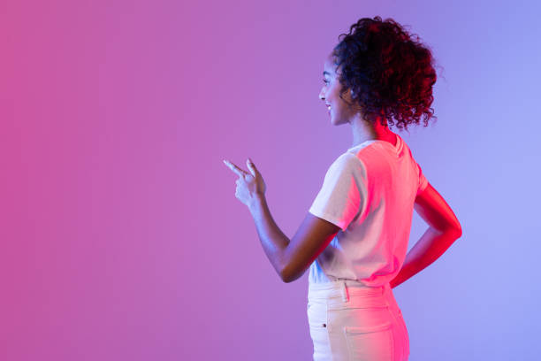 istock Woman pointing at large empty phone screen 2166933556