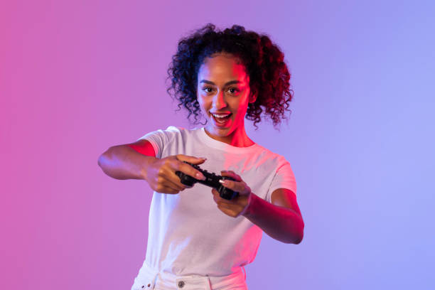 istock Enthusiastic woman gaming with black controller 2166933567