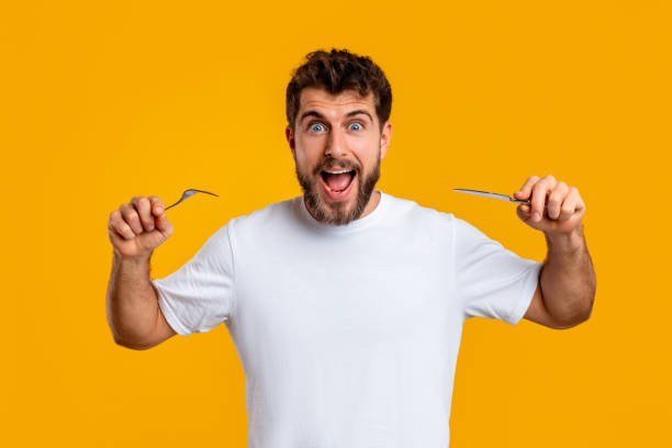 istock Emotional man holding knife and fork ready to eat, studio 2166933814