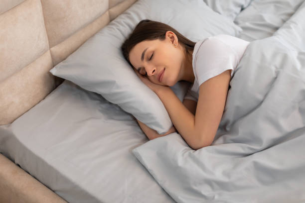 istock Woman sleeping peacefully in comfortable bed 2166934714