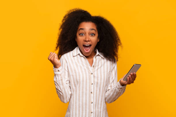istock Woman pumped up looking at smartphone screen 2166934892