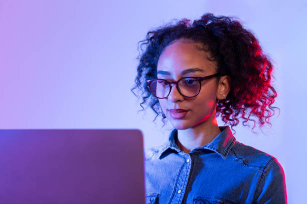 istock Focused young woman working on laptop 2166934984