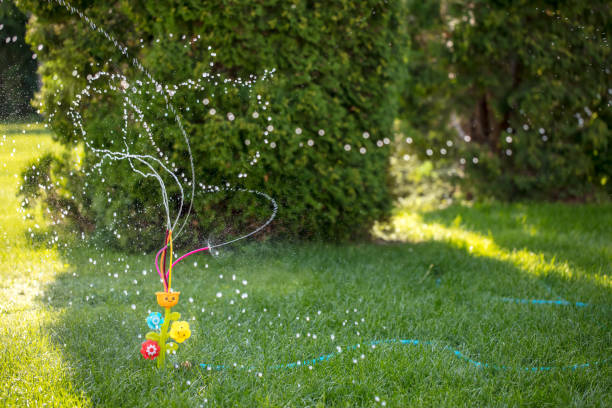 Water splashes and bokeh from watering the grass with sprinkler