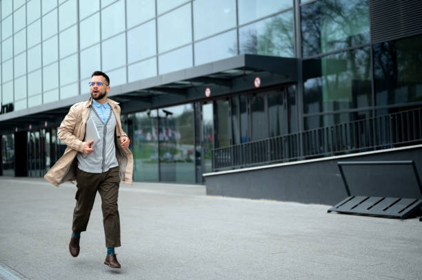 istock Young male businessman in hurry 2166937121
