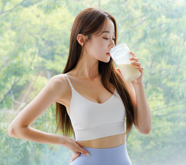 istock Young Asian woman drinking a protein drink 2166939586