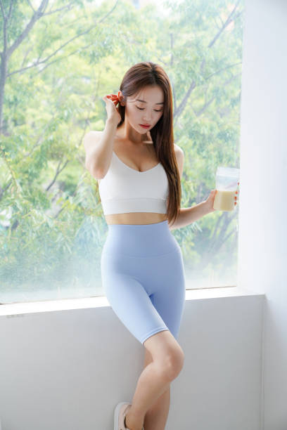 Young Asian woman drinking a protein drink